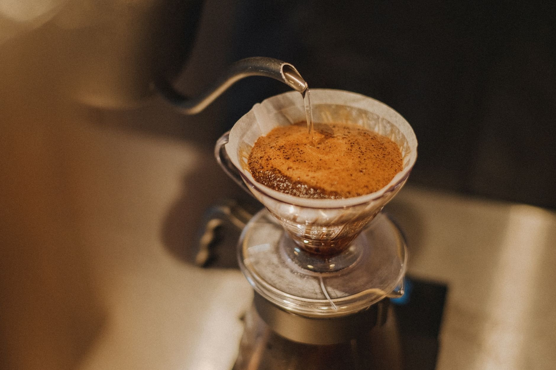 Close-up of pour-over coffee preparation in a café